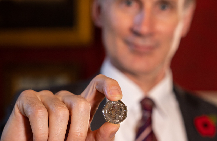 Chancellor Jeremy Hunt shows new coins of the nation